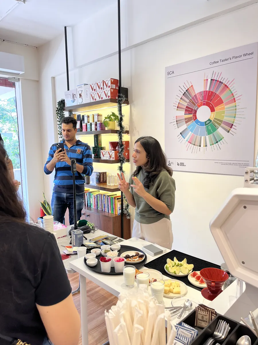 Ananya pouring coffee during a guided tasting